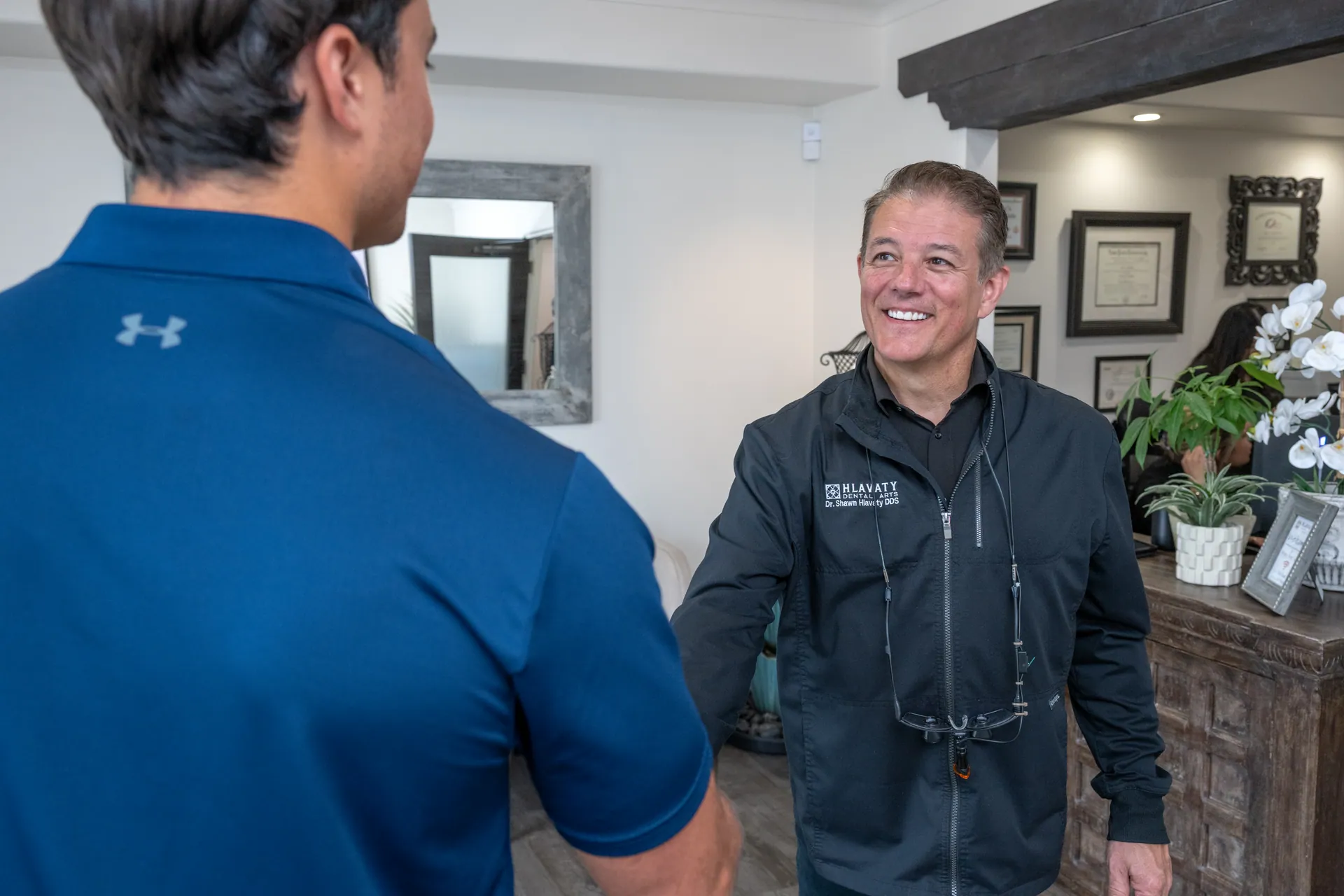 Dr. Shawn Hlavaty warmly greeting a patient at Hlavaty Dental Arts
